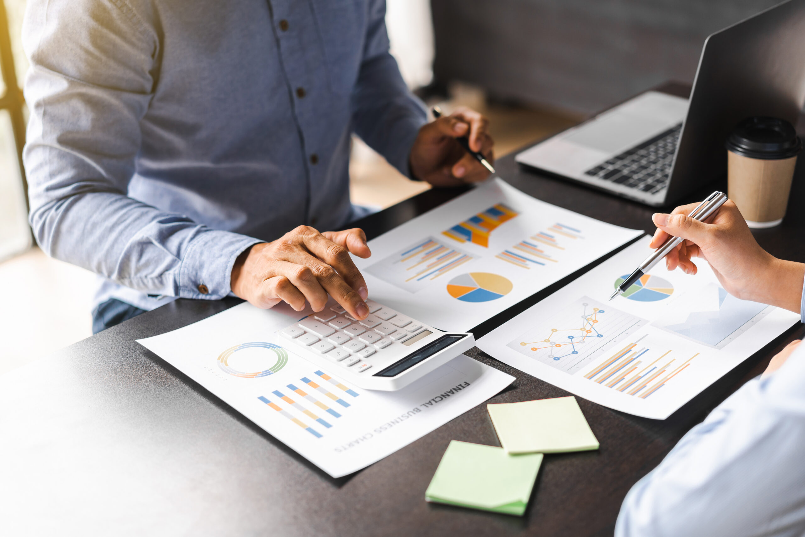 The financiers using calculator calculating personal taxes with